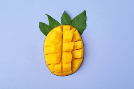 Tasty ripe mango fruit on violet backgroundの写真素材