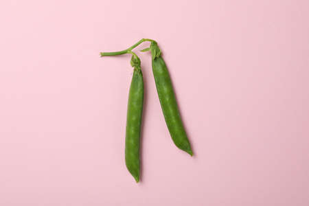 Fresh green pea on pink background, close up