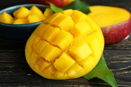 Tasty ripe mango fruit on wooden tableの写真素材