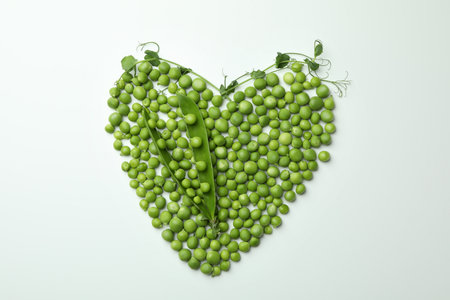 Heart made of pea seeds on white backgroundの写真素材