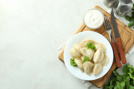 Concept of tasty food with vareniki or pierogi on white textured tableの写真素材