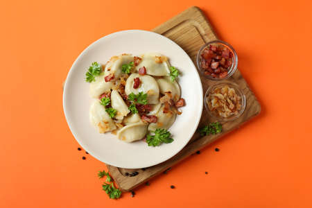 Concept of tasty food with vareniki or pierogi on orange backgroundの写真素材