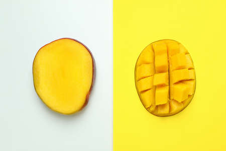 Ripe mango fruit on two tone backgroundの写真素材
