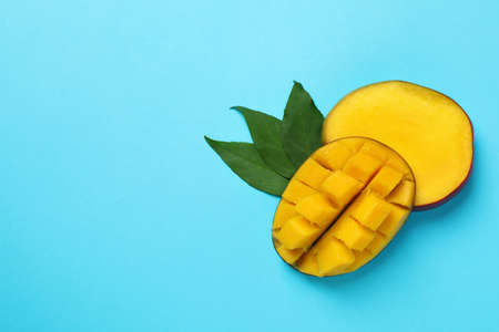Tasty ripe mango fruit on blue backgroundの写真素材