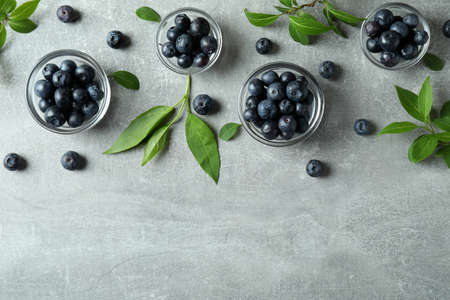 Fresh berry concept with blueberry on gray textured tableの写真素材
