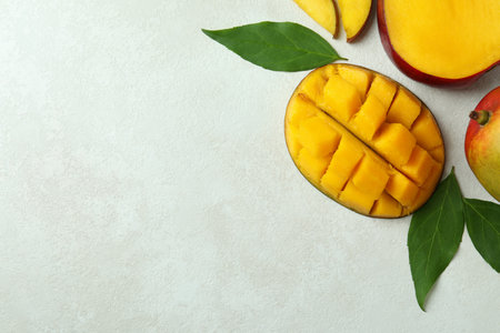 Tasty ripe mango fruit on white textured backgroundの写真素材