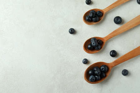 Fresh berry concept with blueberry on white textured tableの写真素材
