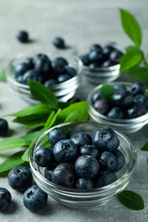 Fresh berry concept with blueberry on gray textured tableの写真素材