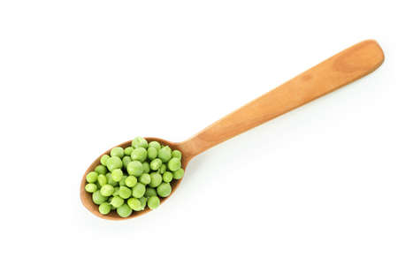 Spoon with pea seeds isolated on white background
