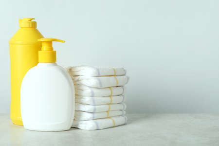 Baby hygiene accessories on white textured tableの写真素材
