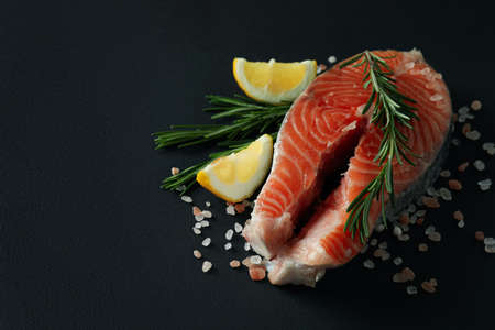 Fresh raw salmon and spices on black backgroundの写真素材