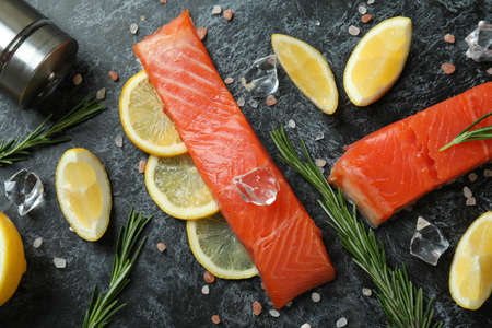 Concept of cooking salmon on black smokey backgroundの写真素材