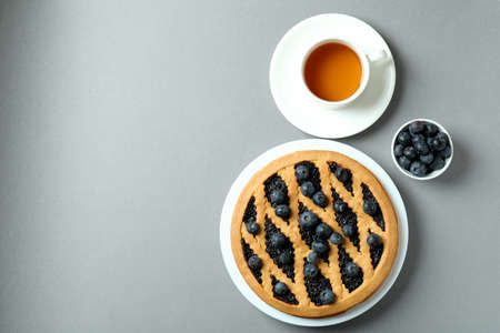 Concept of delicious breakfast with blueberry pie on gray backgroundの写真素材