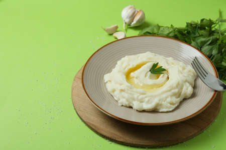 Concept of tasty eating with mashed potatoes on green backgroundの写真素材
