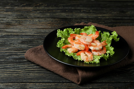 Plate with grilled shrimps on rustic wooden backgroundの写真素材