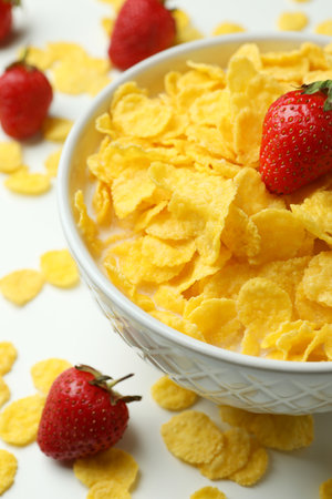 Concept of tasty breakfast with cornflakes and strawberry on white backgroundの写真素材