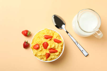 Concept of tasty breakfast with cornflakes on beige background
