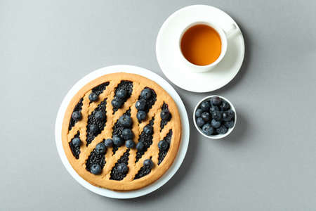 Concept of delicious breakfast with blueberry pie on gray backgroundの写真素材