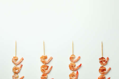 Tasty grilled shrimps skewers on white backgroundの写真素材
