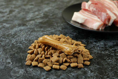 Concept of natural pet food on black smokey background