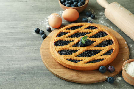 Concept of cooking blueberry pie on gray textured backgroundの写真素材