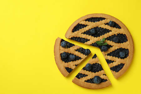 Delicious blueberry pie with berries on yellow backgroundの写真素材