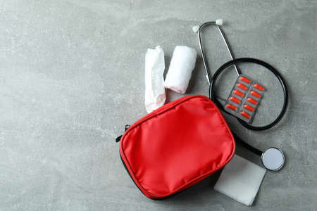 First aid medical kit on gray textured tableの写真素材