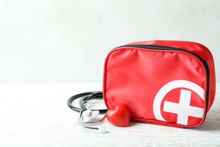 First aid medical kit on white wooden tableの写真素材