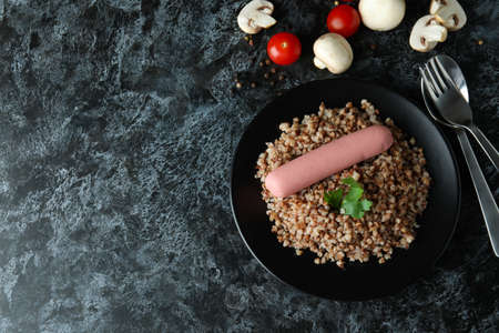 Concept of tasty eating with buckwheat on black smokey tableの写真素材