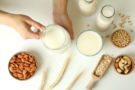 Concept of vegan milk on white background, top view