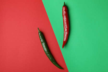 Red and green hot chili peppers on two tone backgroundの写真素材