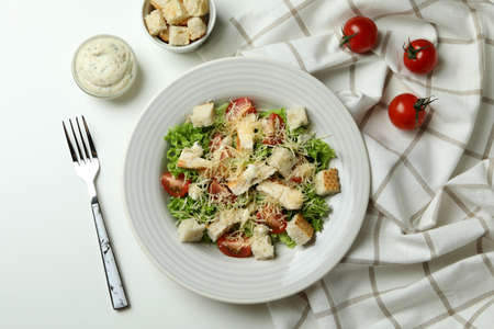 Concept of tasty eating with Caesar salad on white tableの写真素材