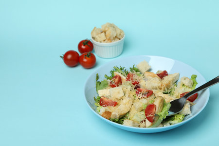 Concept of tasty eating with Caesar salad on blue backgroundの写真素材