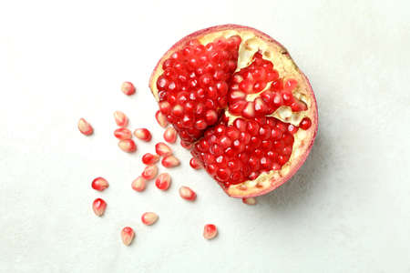Ripe pomegranate on white textured background, close upの写真素材