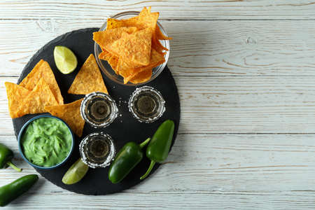 Party concept with tequila, guacamole and chips