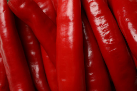 Red hot chili peppers on whole background, close up