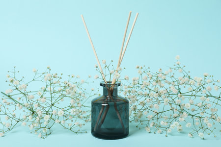 Aroma scent diffuser and flowers on blue backgroundの写真素材