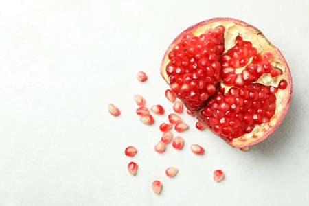 Ripe pomegranate on white textured background, close upの写真素材