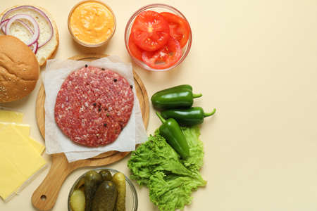 Concept of cooking burger on beige backgroundの写真素材