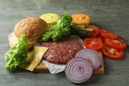 Concept of cooking burger on gray textured tableの写真素材