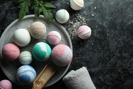 Body care concept with bath balls on black smokey tableの写真素材