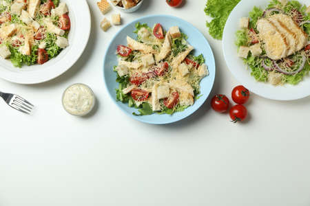 Concept of tasty eating with Caesar salad on white backgroundの写真素材