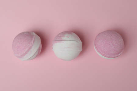 Bath balls on pink background, space for text
