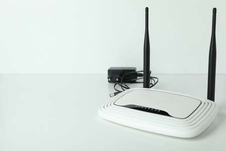 Wi Fi router with external antennas and plug on white background