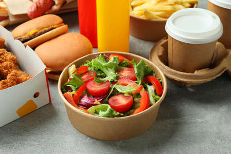 Different fast food on gray textured table