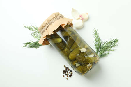 Jar of pickles and ingredients on white backgroundの写真素材