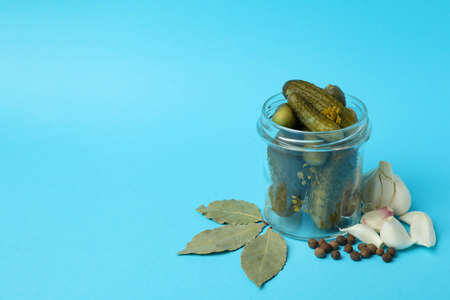 Jar with ingredients for cooking pickles on blue backgroundの写真素材
