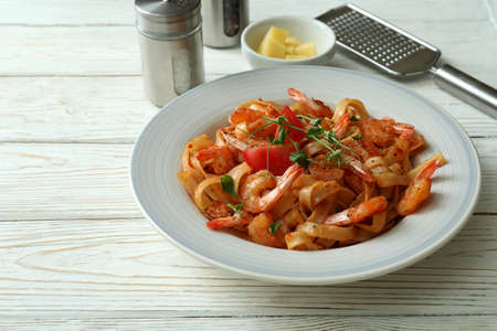Concept of cooking shrimp pasta on white wooden tableの写真素材