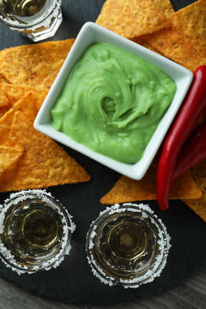 Party concept with tequila, guacamole and chips