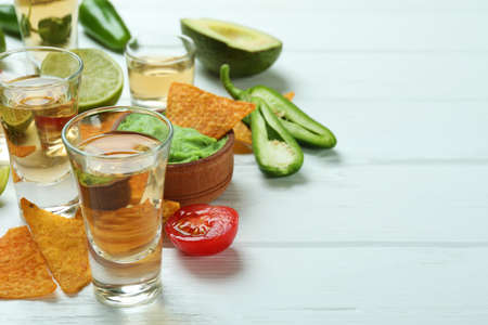 Party concept with tequila, guacamole and chipsの写真素材